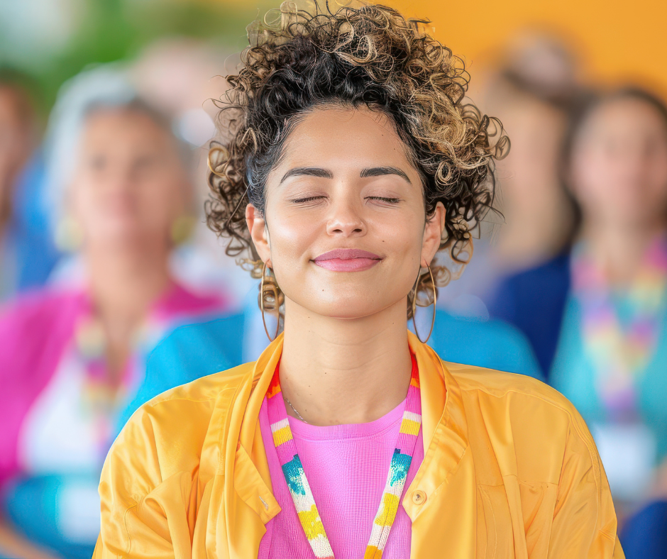 young women, eyes closed, wearing bright colors. Others behind her. Warm and inviting